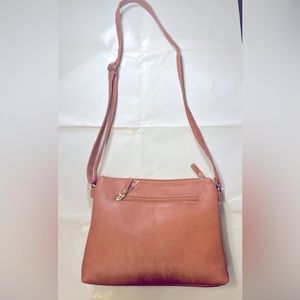 Brand new women’s  light brown  vegan leather hand bag with adjustable handle.